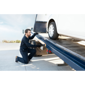 tow truck operator towing a car